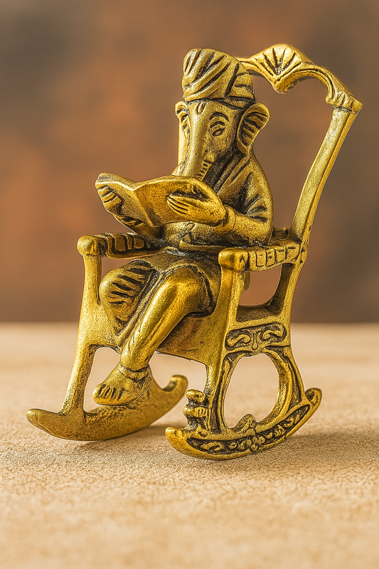 Golden Lord Ganesha Statue Sitting On A Rocking Chair And Reading Ramayan Showpiece